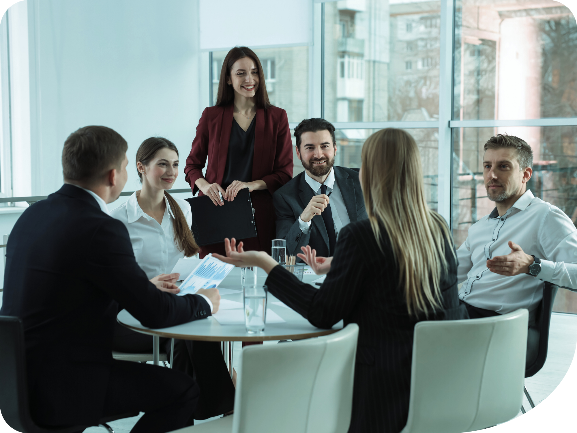 A group of professionals have a discussion at a table.